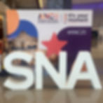 "ANC 2025 Annual National Conference" display with #ANC25 hashtag. Large white "SNA" letters in front, set in a modern lobby.