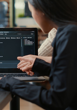 team-programmers-talking-about-algorithm-running-laptop-screen-pointing-source-code-while-