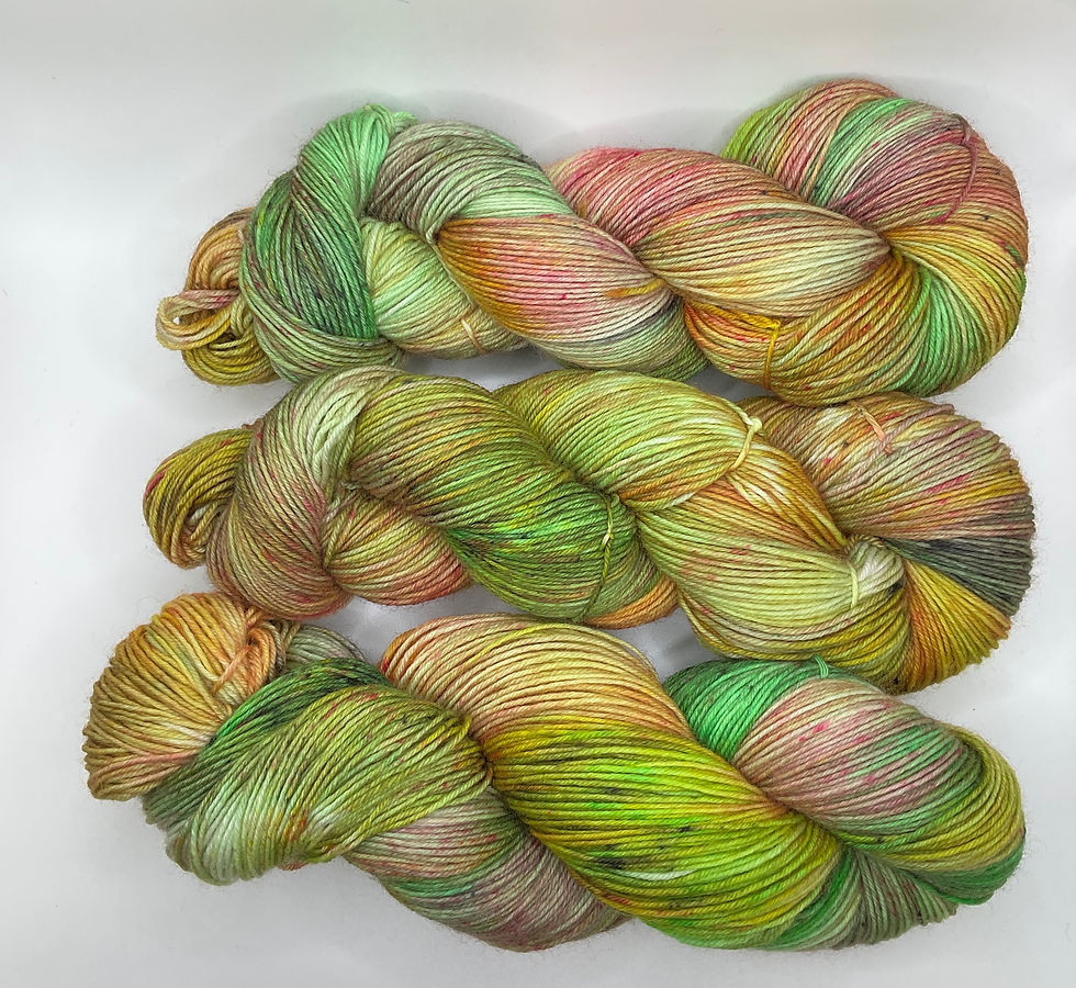 Thumbnail: Three hanks of hand dyed yarn variegated shades of pink, yellow and green.