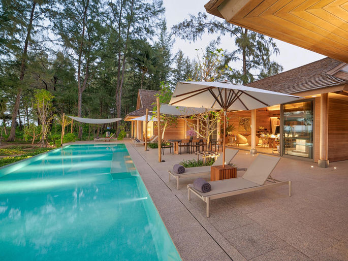 Exclusive luxury beachfront villa in Phuket with private pool and sun loungers for family holidays at The Pines Natai Beach.