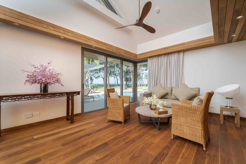 Elegant Phuket beachfront villa bedroom with garden view and four-poster bed
