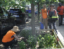 Volunteers Natasha, Stephanie and Anne planting and watering tree bed. Photo by Lisa Ising.