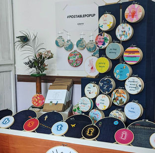 Little Light Stitchery's homemade market stalls displaying decorated embroidery hoops.