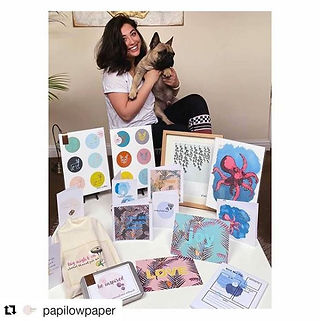 A homemade market stall displaying hand illustrated, nature themed prints. 