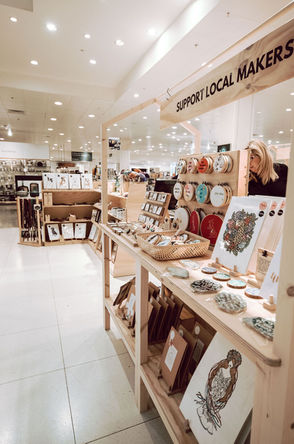 A Curated Makers fixture displaying colourful hand designed products in a John Lewis Pop-Up.