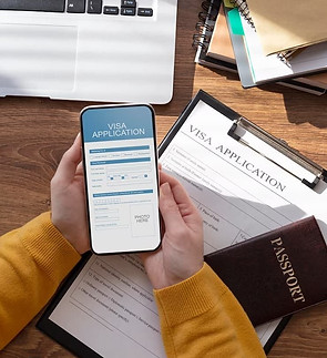 A person is holding a smartphone with a visa application form on it