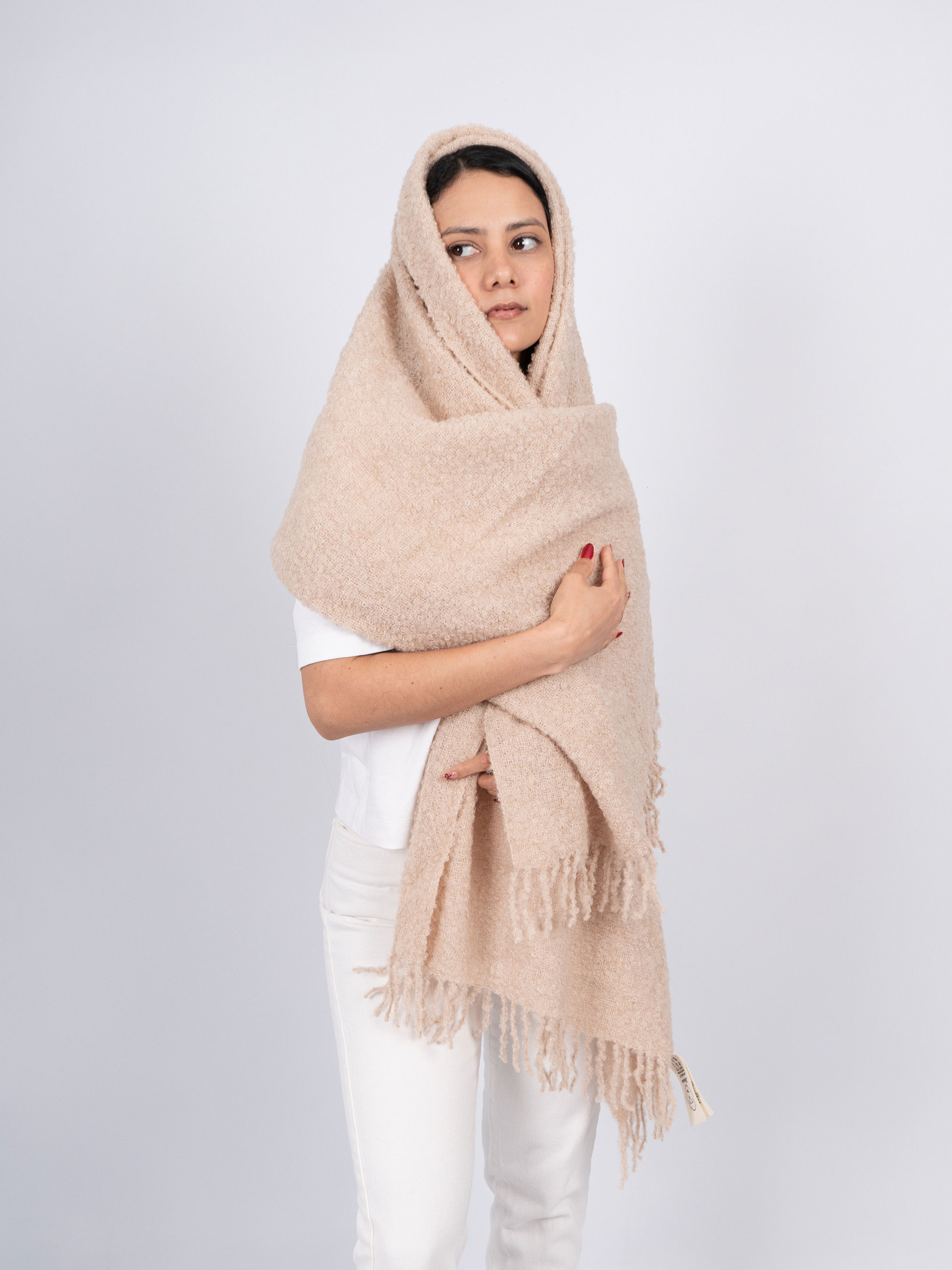 Beigefarbene Alpaka-Stola Ñusta aus Bouclé, getragen von einem Model