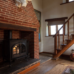 Log burner with brick fireplace and bull head wall art