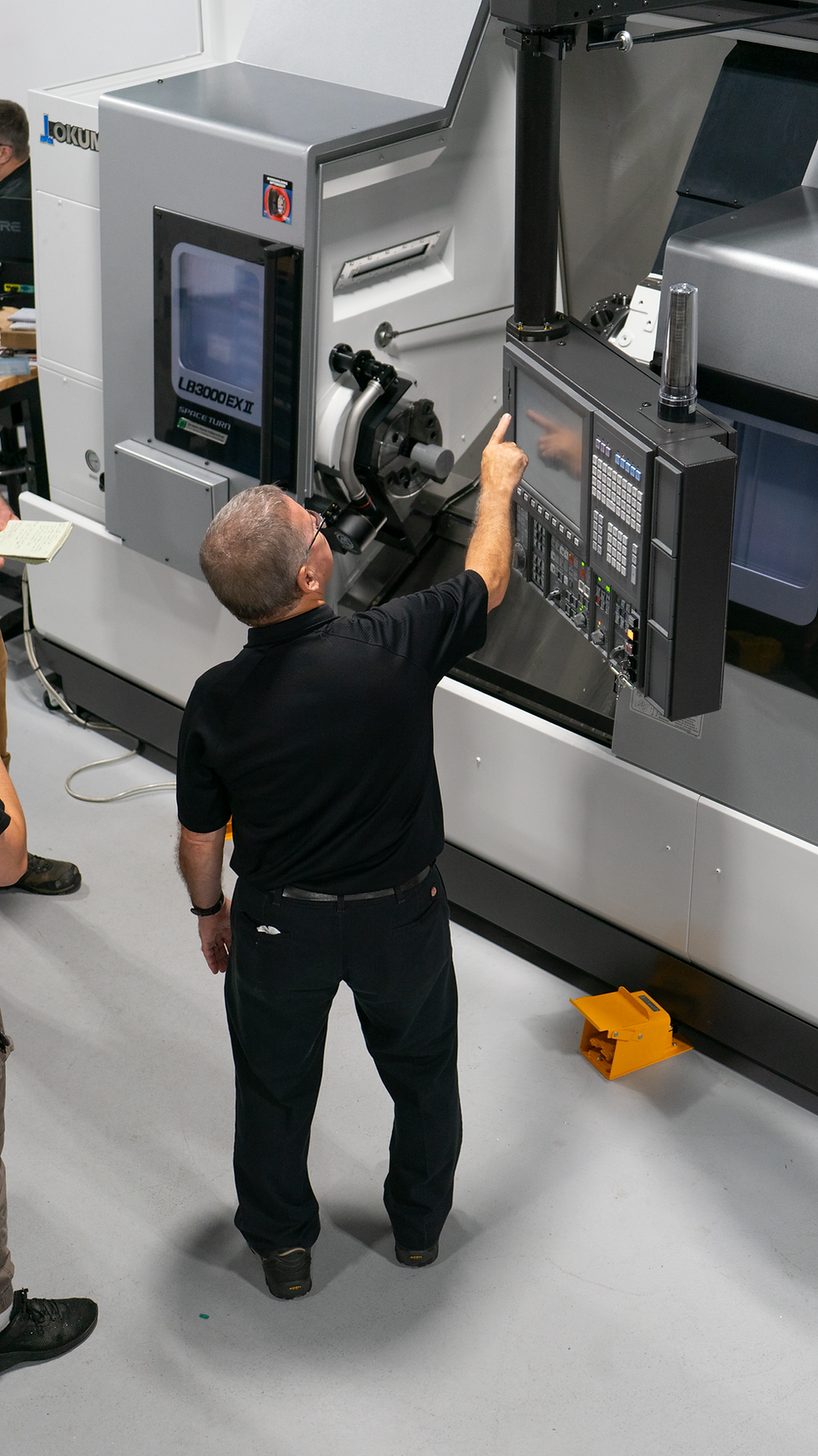 Morris applications engineer explaining function on Okuma OSP-300 CNC control