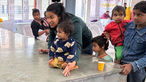 A therapist energetically engages children in a playful and interactive session, using bubbles as a tool to foster connection and joy in a therapy setting.