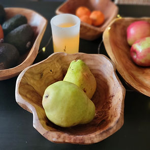 Two pears in wooden root bowl.