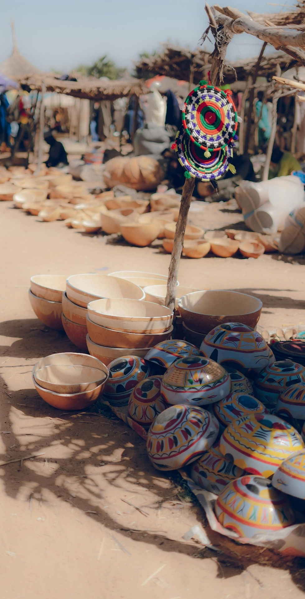 https://images.pexels.com/photos/29630126/pexels-photo-29630126/free-photo-of-colorful-pottery-display-at-nigerian-market.jpeg