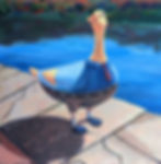 Goose in blue shirt and tie standing by a river