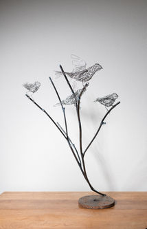 Sculpture of steel woven sparrows on steel branches and found objects. Artist Shona Rapira-Davies.