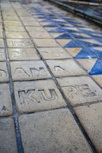 Close up of public park sculpture tiles in foreground. Artist Shona Rapira-Davies.