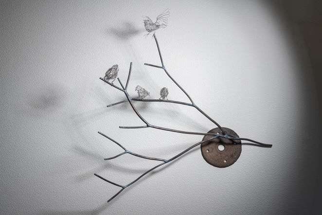 Sculpture of steel woven sparrows on steel branches and found objects. Artist Shona Rapira-Davies.