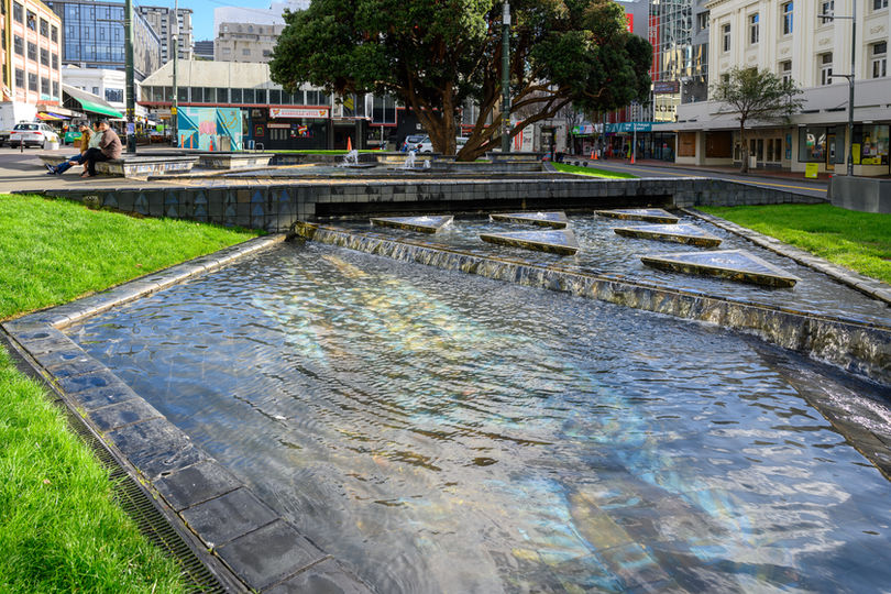 Photo of shallow water feature with image of women underneath the water.