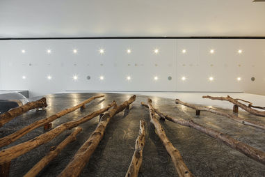 Sculpture of maori palisades with small bubble windows showing military figurines.