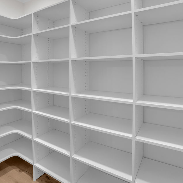 Pantry with white solid surface shelving