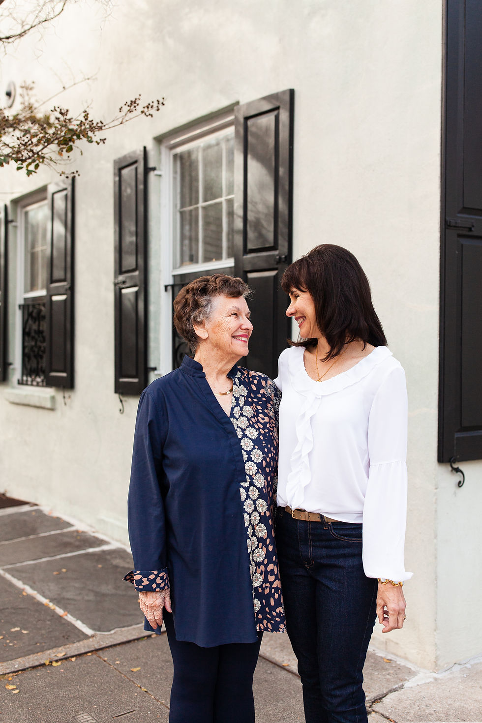 A mom and her daughter looking at each other smiling