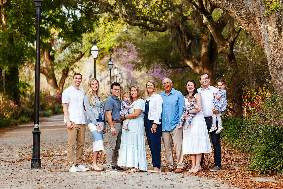 Extended Family standing on a dirt path under the oak trees.