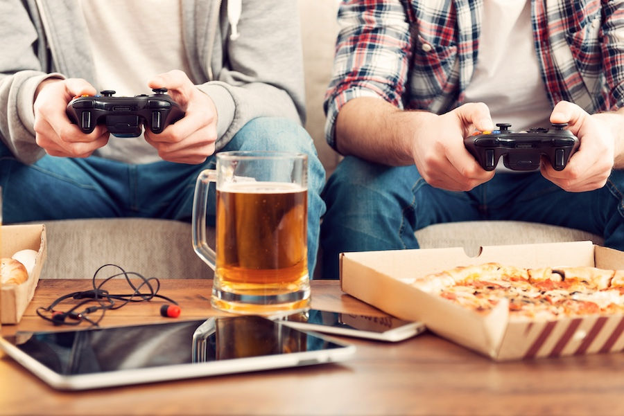 playing-video-games-close-up-two-men-playing-video-games-while-sitting-sofa.jpg