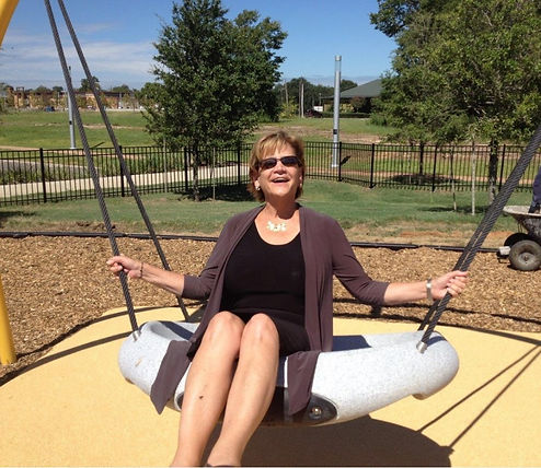 Founder, Carolyn Channey on a Swing