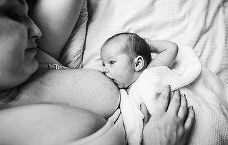 mom is breastfeeding baby boy