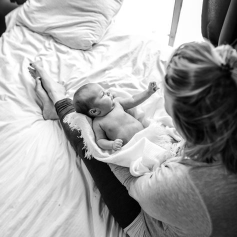 postpartum mother with newborn on a cozy bed