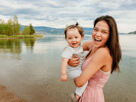 mom &baby on beach taking photographs in Penticton BC