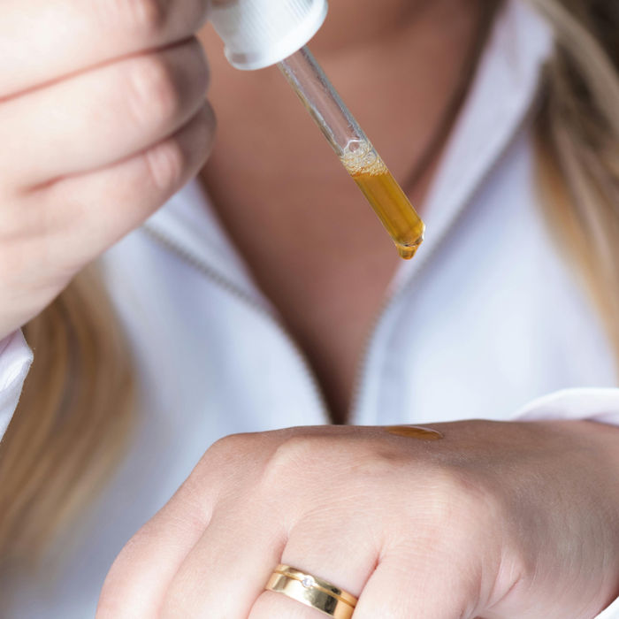 women applying essential oil
