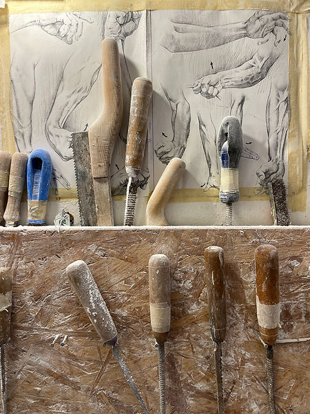 Alabaster carving tools and pencil sketches of hands