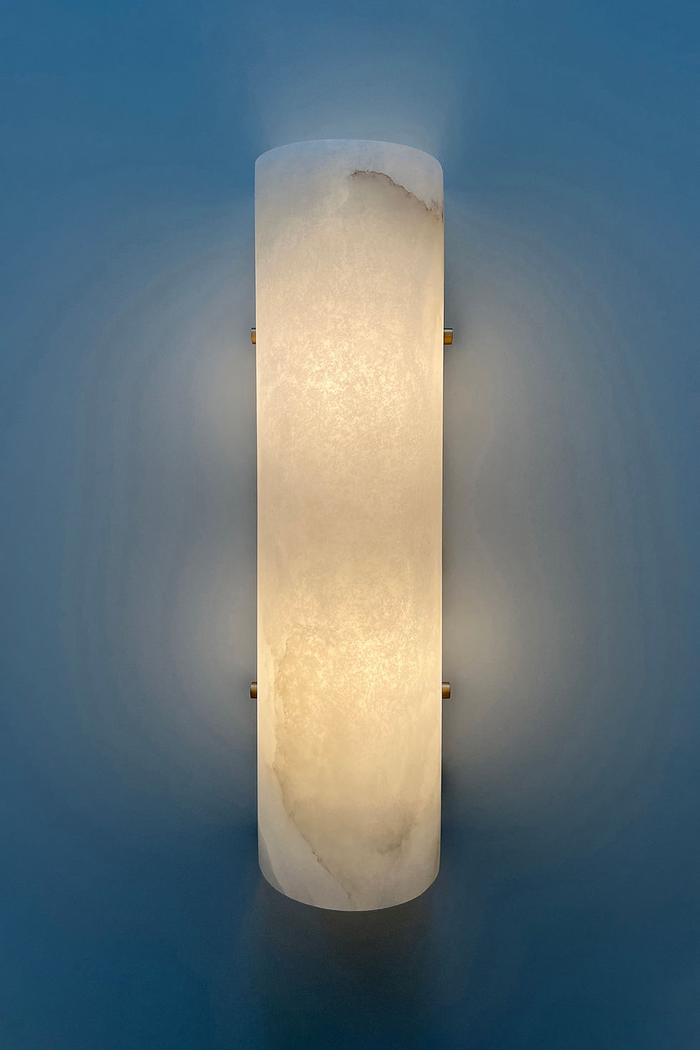 Thumbnail: Domo alabaster sconce finished in brushed brass, front view, light on