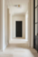 Thumbnail: Dark door in a long, bright hallway