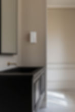 Alabaster wall lamp illuminates modern bathroom vanity