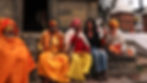 yoga teacher sitting with monks in nepal bright pretty colors