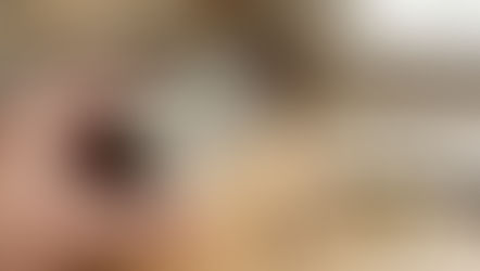 Hands reading a Supplement Facts label on a cardamom supplement bottle next to cardamom capsules.