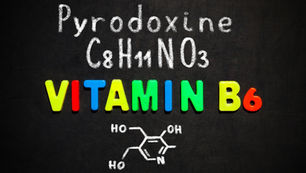 Colorful letters spell "VITAMIN B6" on blackboard, with "Pyrodoxine," "C8H11NO3," and chemical structure drawn in white chalk above.