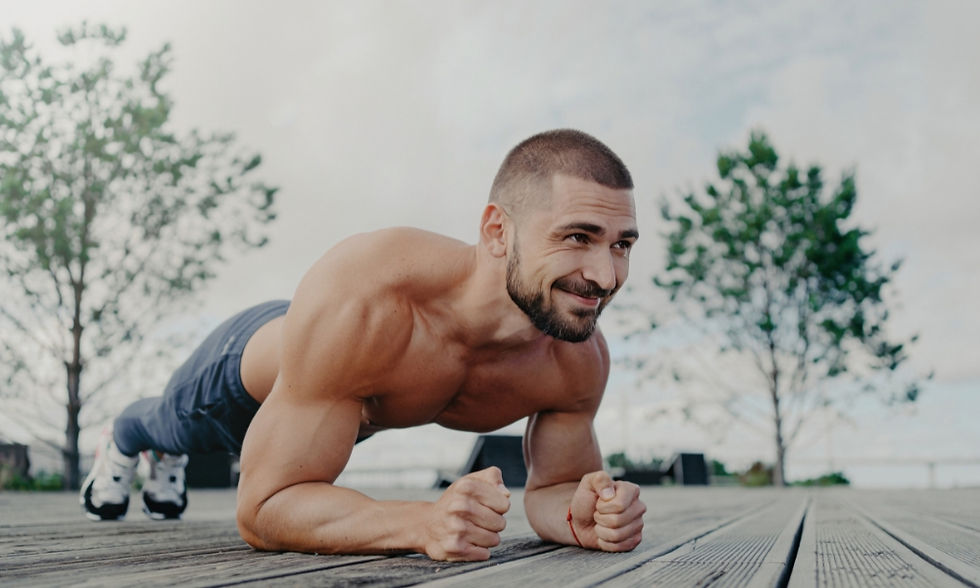 Man doing a plank on wooden deck, outdoors, with trees and cloudy sky in background. He's smiling, wearing dark pants, creating a positive mood. Ginseng and Rhodiola for Energy and Stress Relief. Herbpy Blog.