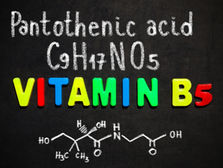 Colorful letters spell "Vitamin B5" on a blackboard, with "Pantothenic acid," "C9H17NO5," and a molecular structure in white chalk. Source: Canva