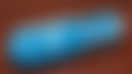 Blue capsule labeled "Zn 30 zinc," filled with Zn-marked blue balls, on a wooden surface. Clean and clinical appearance.