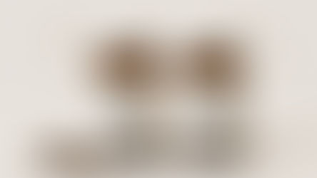 Clove Capsules for Men vs Women. Two brown bottles labeled "MEN" and "WOMEN" in a minimalist setting with male and female symbols. Cloves are scattered nearby.