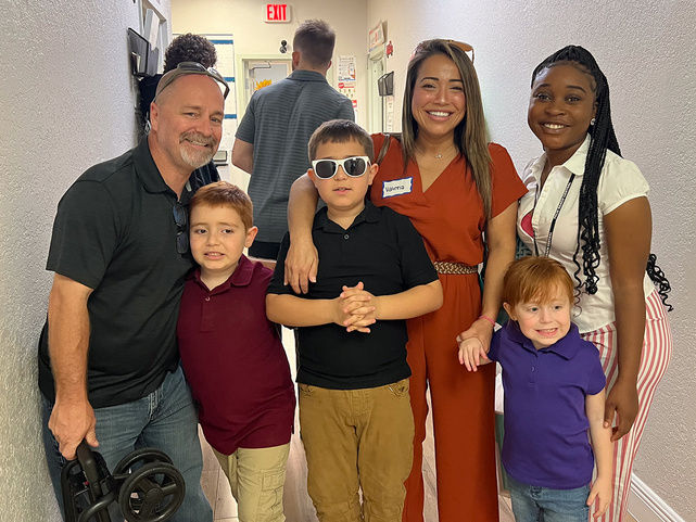 Adelen is shown with her family at a school event