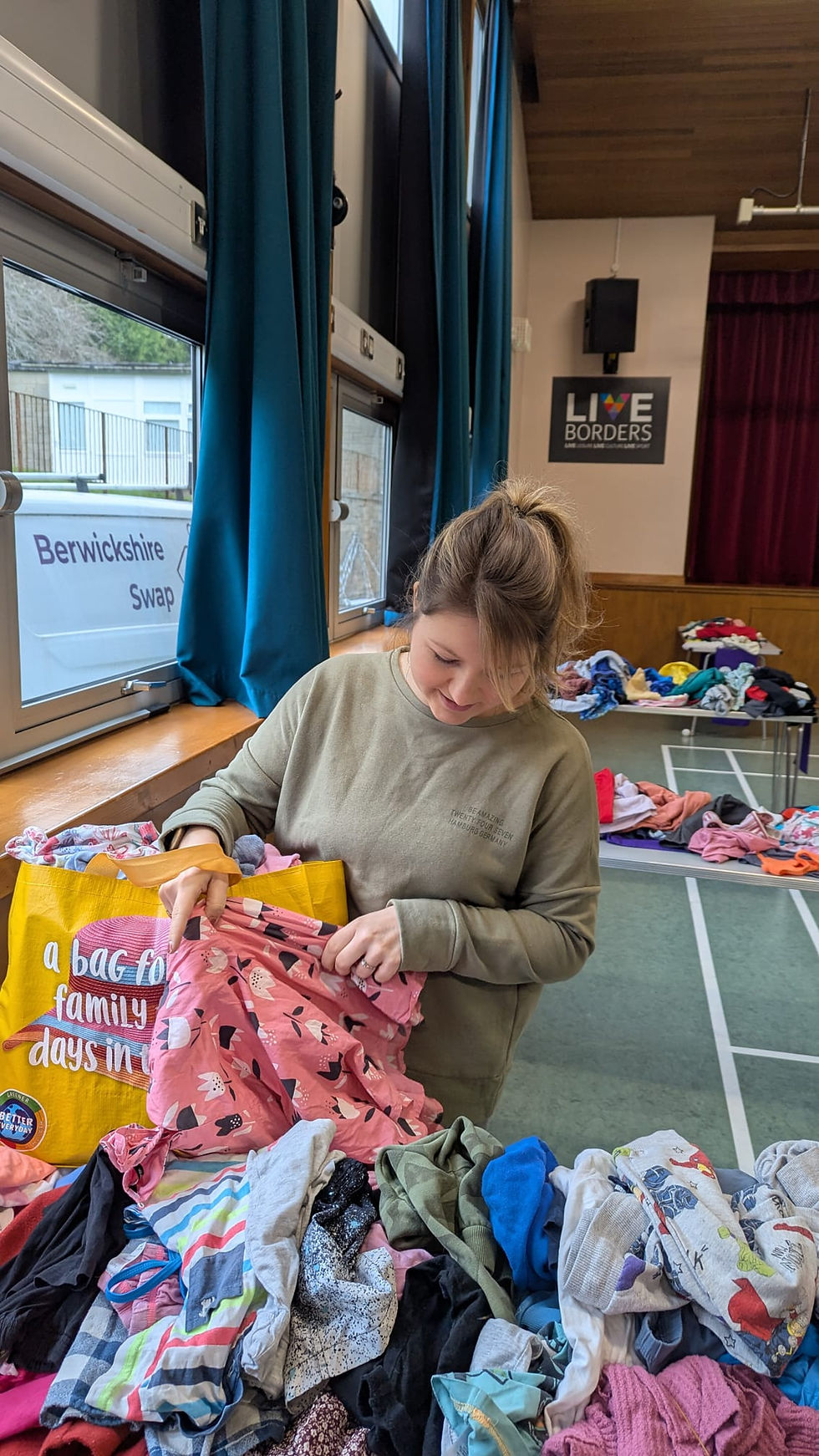 Chloe choosing clothes at a Swap