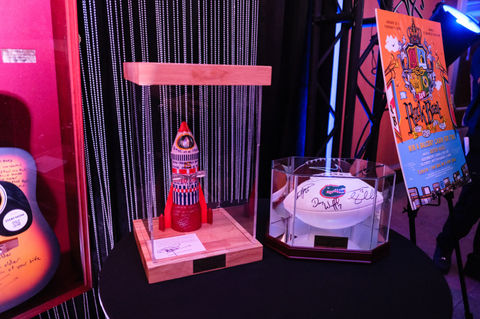 Auction items in glass case at a Gainesville Lyrics for Life event.