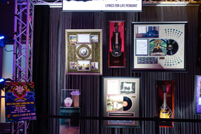 A variety of silent auction items hanging on the wall.