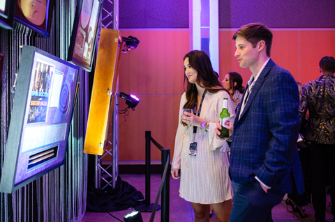 A couple browses through the items on the wall at the silent auction.