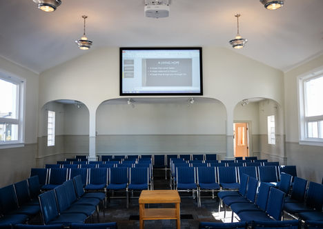 Empty auditorium with rows of chairs and a presentation screen. Ottawa Gospel Hall.
