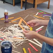 Someone holding popsicle sticks