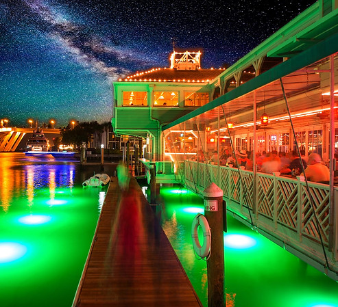 This is a glowing image of the Lauderdale Marina dock and seating area downstairs on the watefront at Fisheries Dockside.